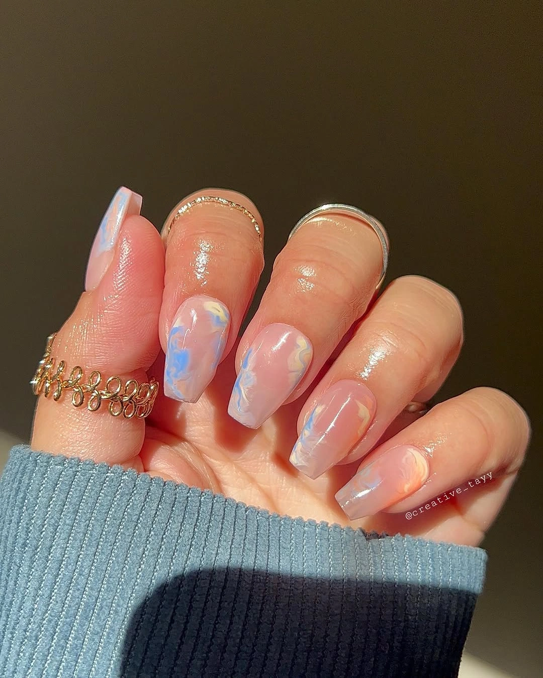 Short translucent peach nails with blue lilac accents