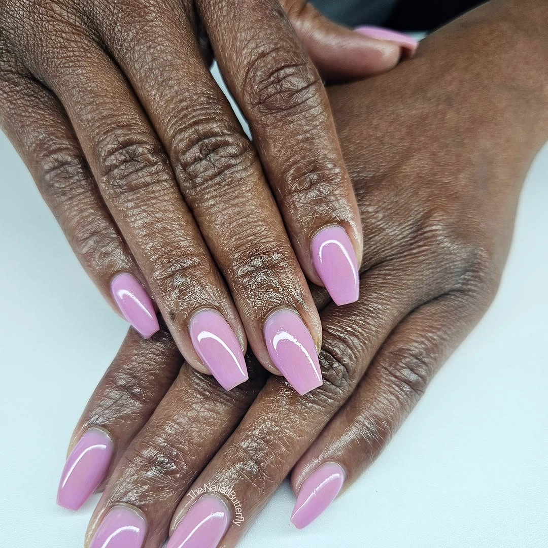 Long almond nails in a uniform glossy lavender shade