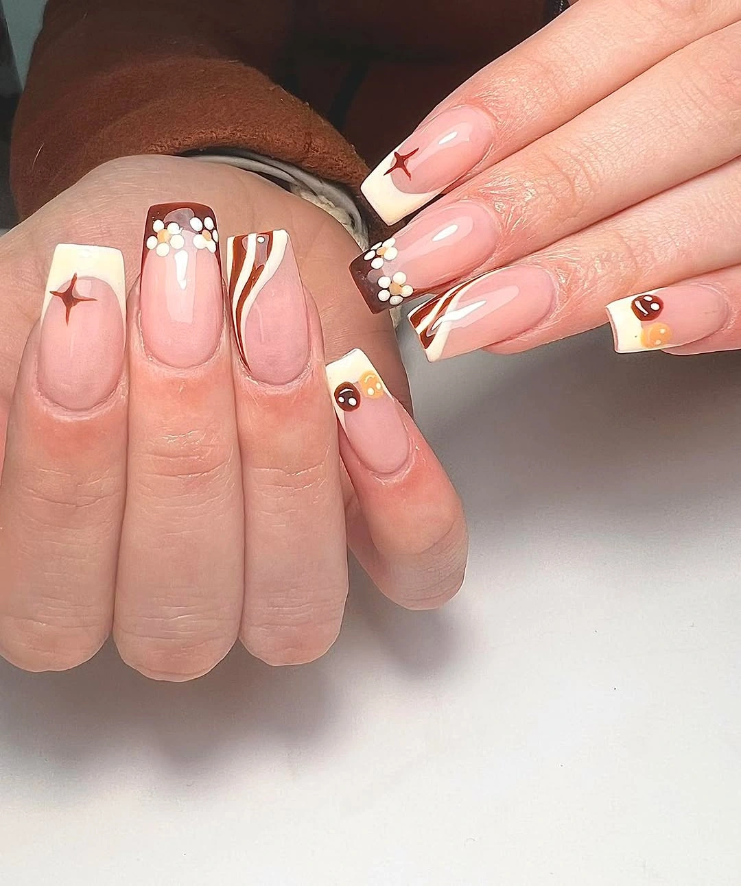 Short nude nails with white red and tiny warm accents