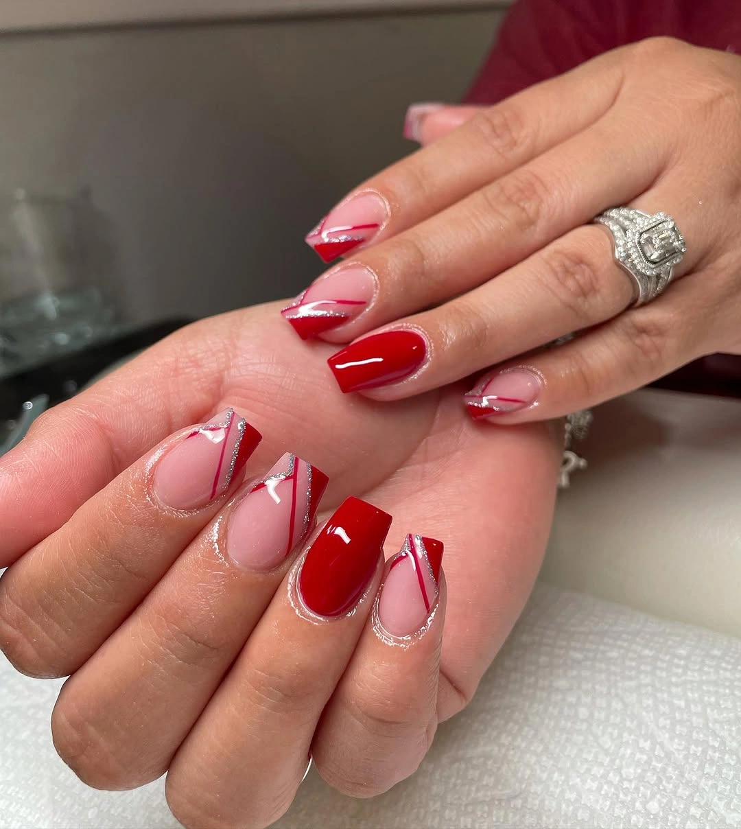 Short red pink French nails with curved white space