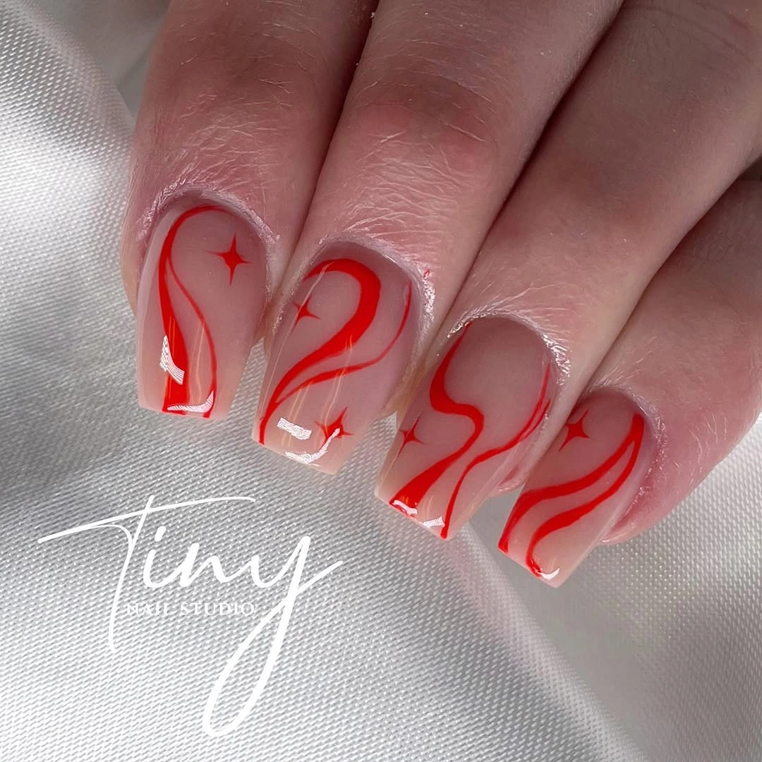 Short translucent nails with looping red line art