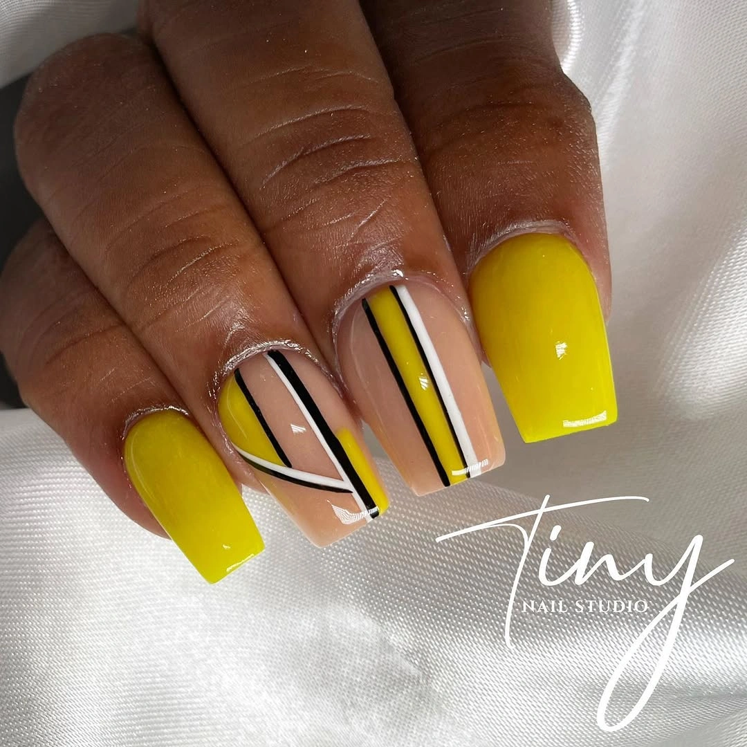 Short square yellow nails with black white vertical stripes