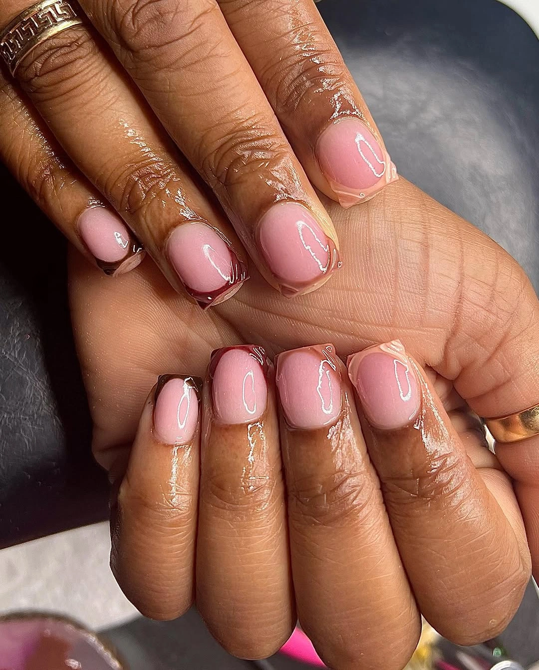 sheer pink short nails with burgundy French tips