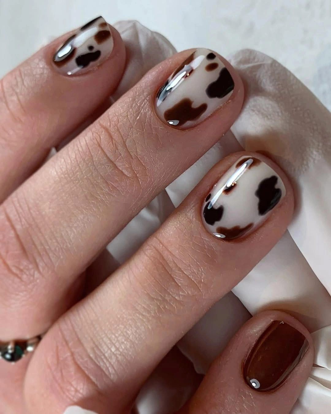 tiny brown cow print on milky short nails
