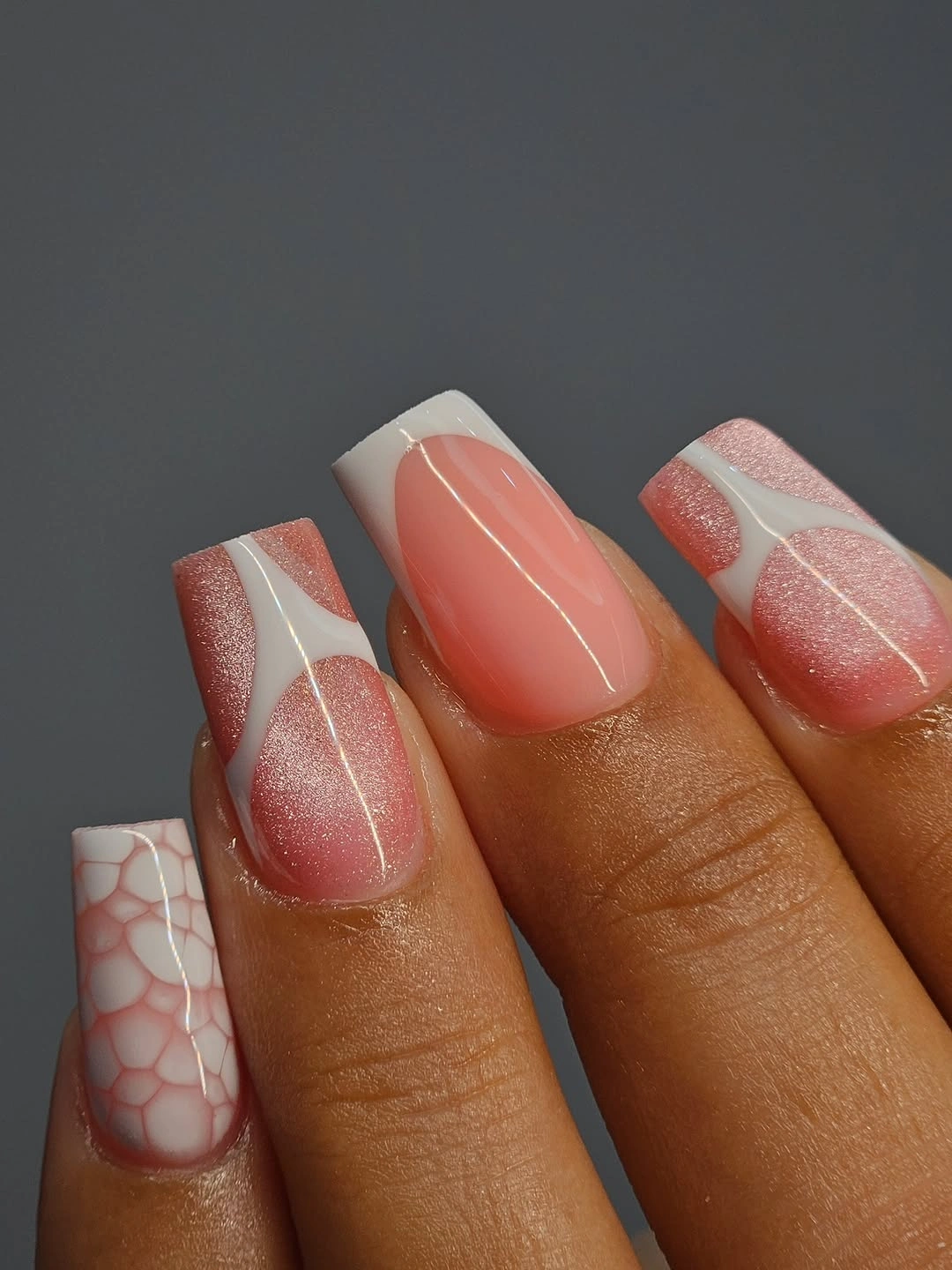 Peach square nails with white outlined tips and fine accent pattern