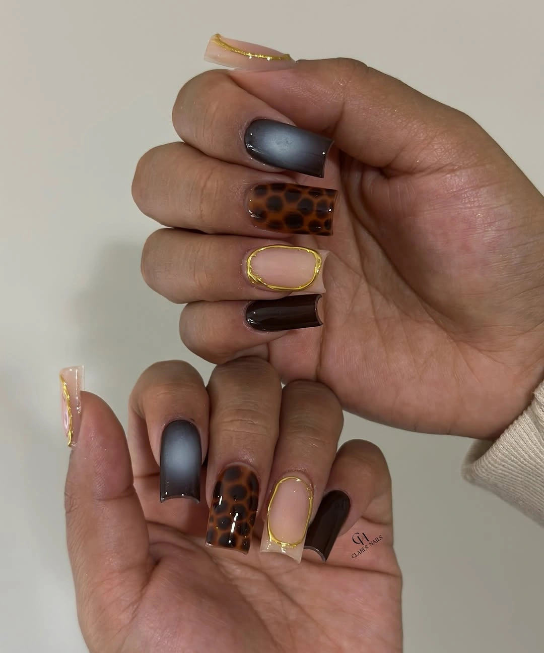 Short brown square nails with checkerboard and earthy accent details