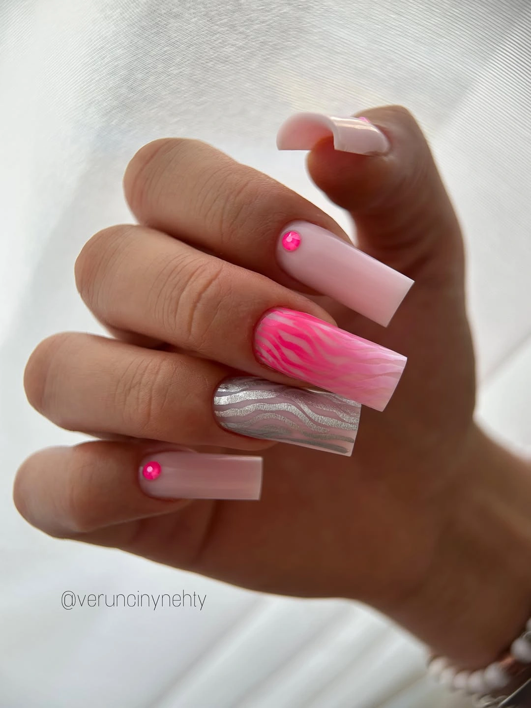 Long translucent pink square nails with vivid pink abstract accents