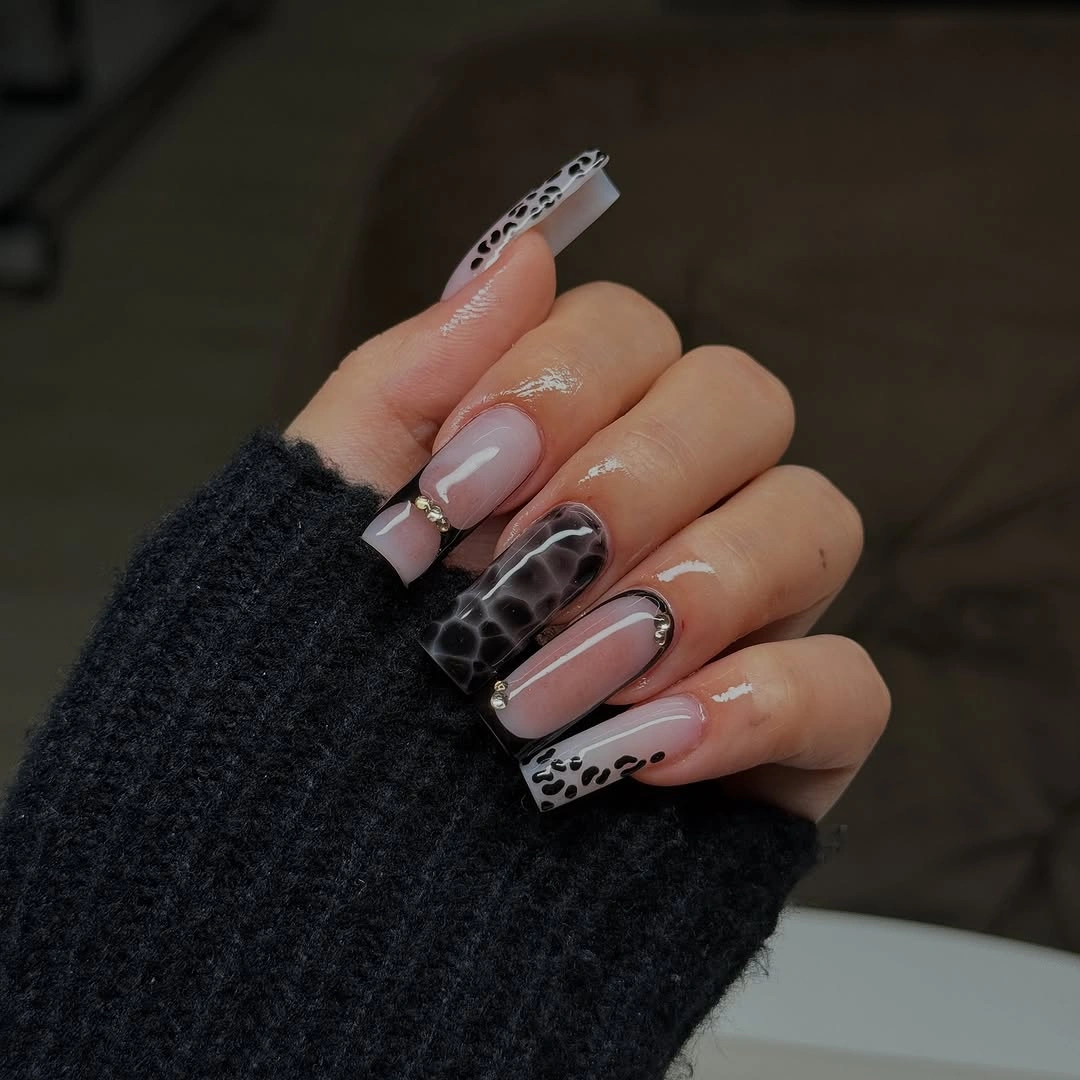 Nude square nails with dark black and white patterned tips