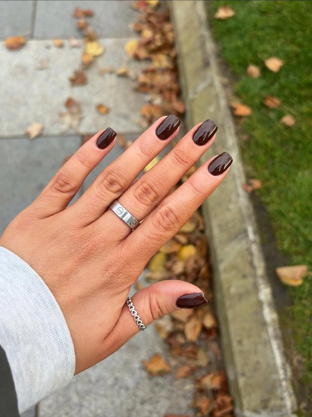 Nude square nails with dark brown pointed French tips