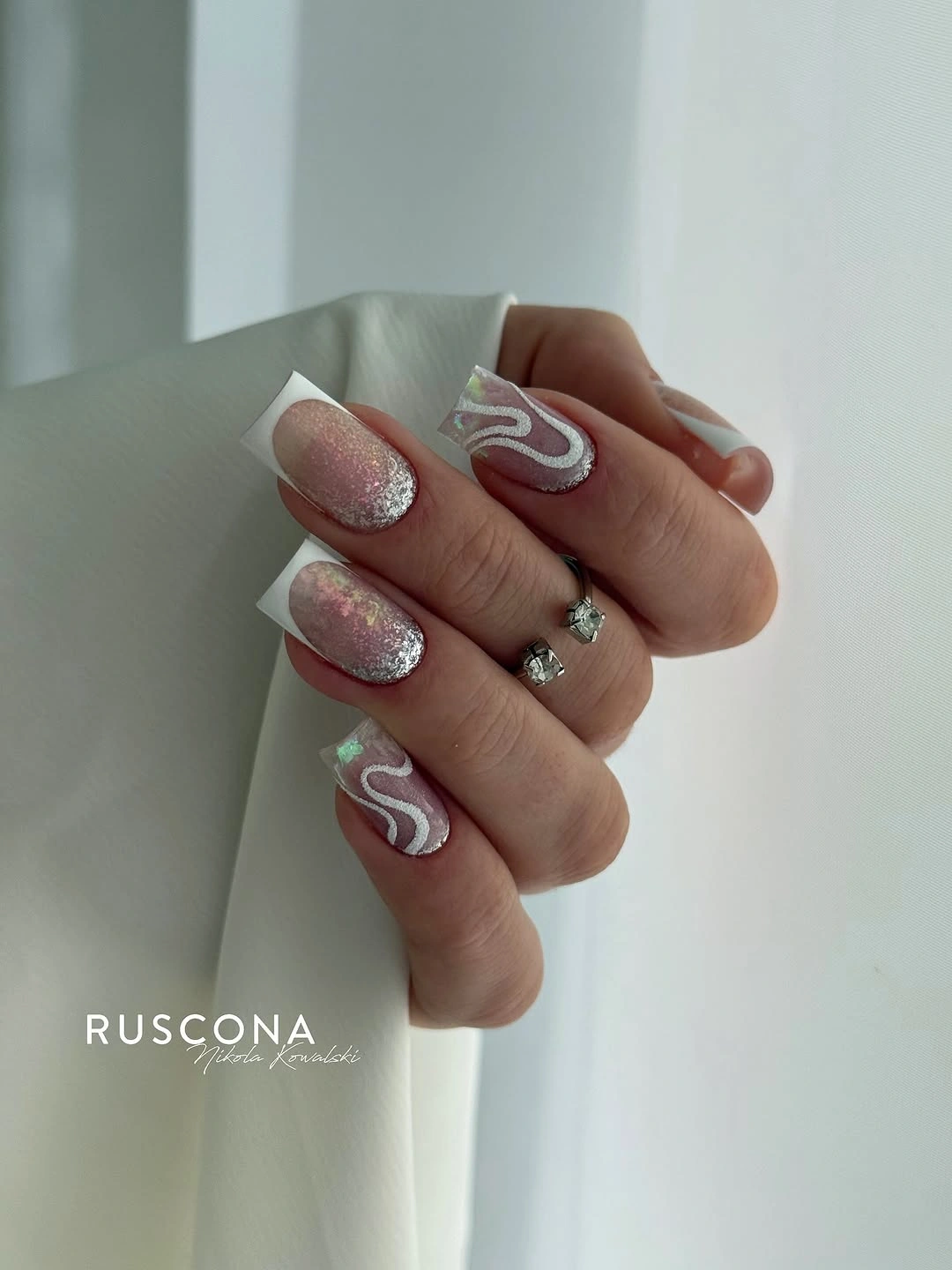 Medium square nails in white pink sparkle and curved line accents
