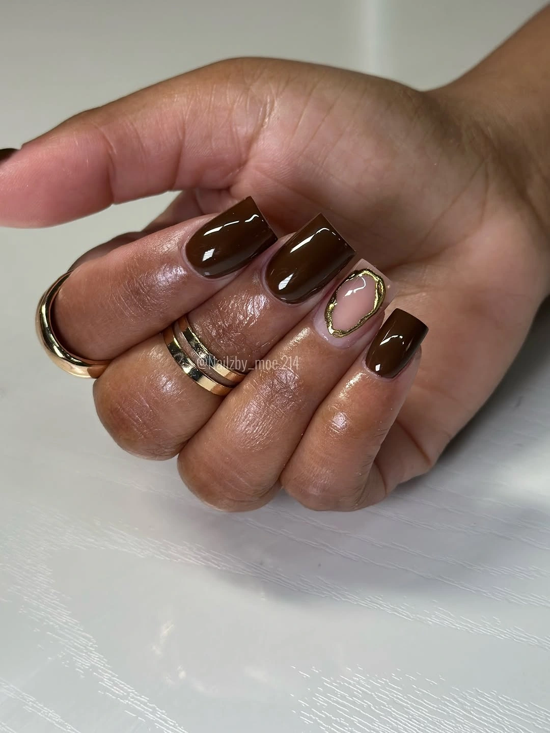 Short chocolate brown square nails with small curved accent lines