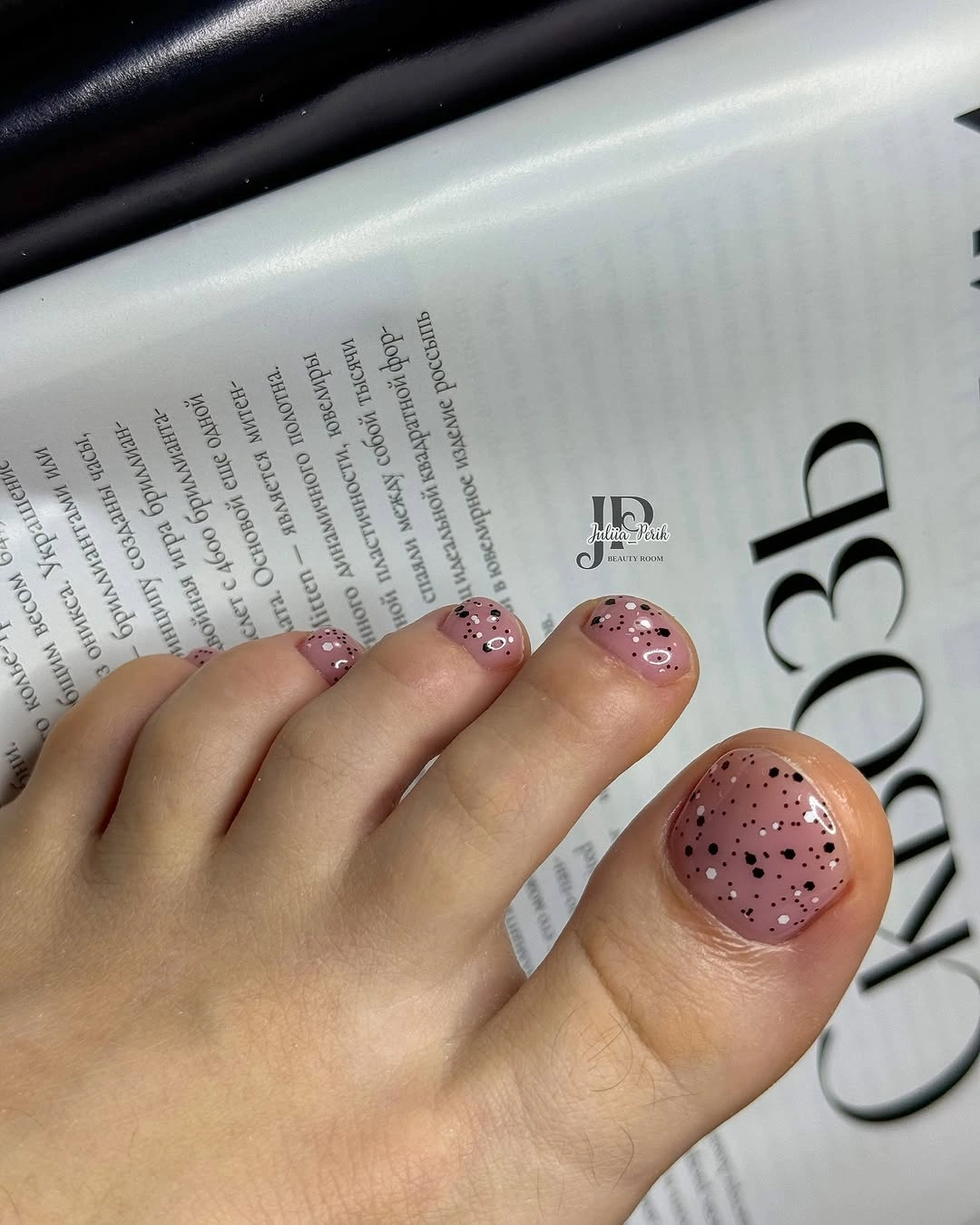 Pale peach pink toes with a glittered speckled big toe