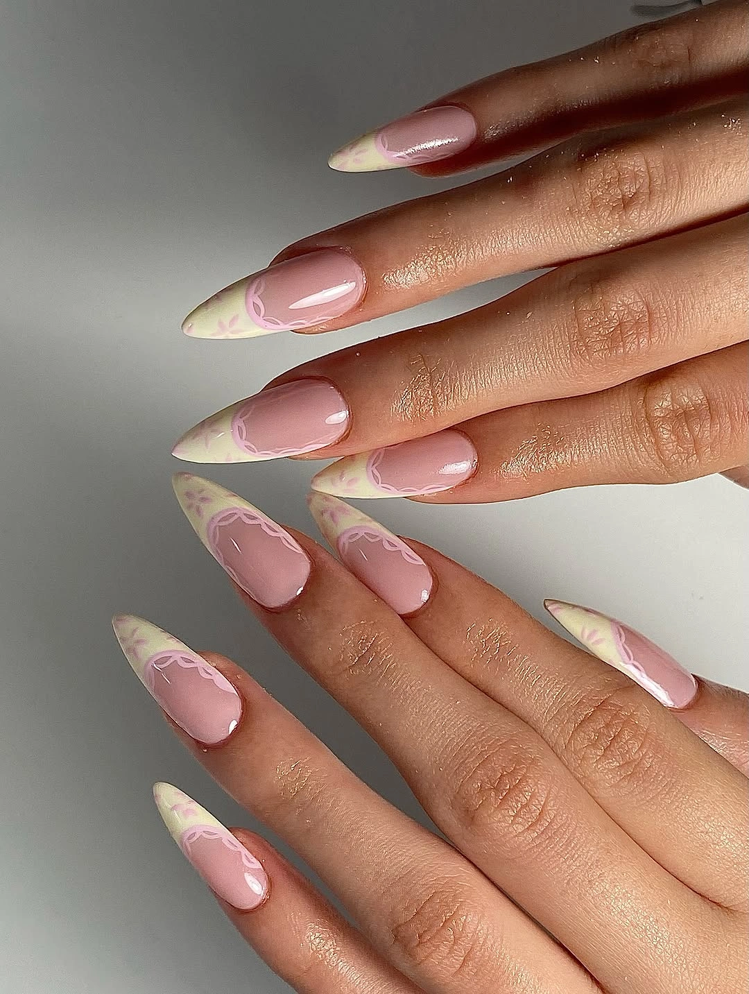 Long almond nails with soft yellow pink and blue French swirls
