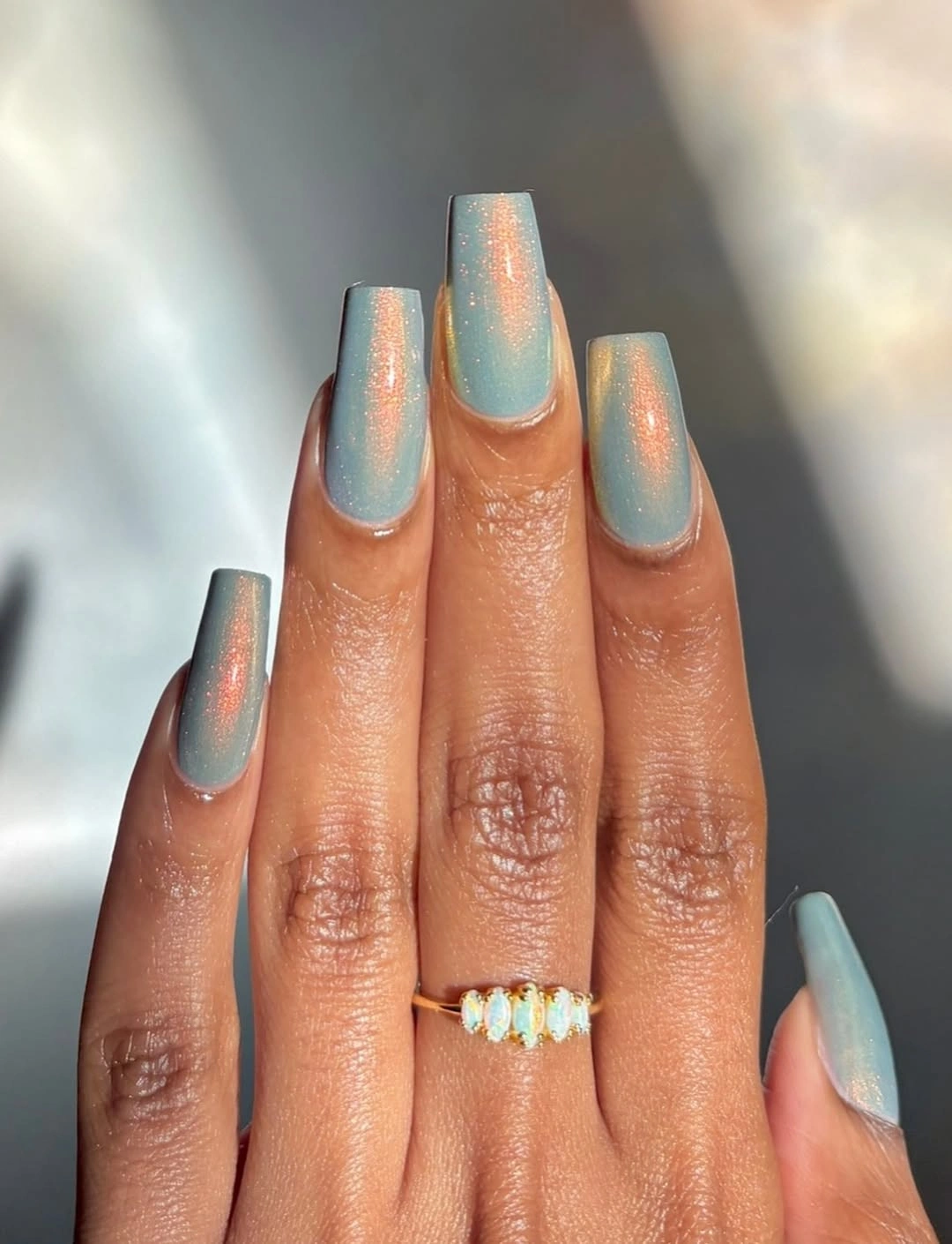 Glossy bright aqua blue square nails in a simple shape