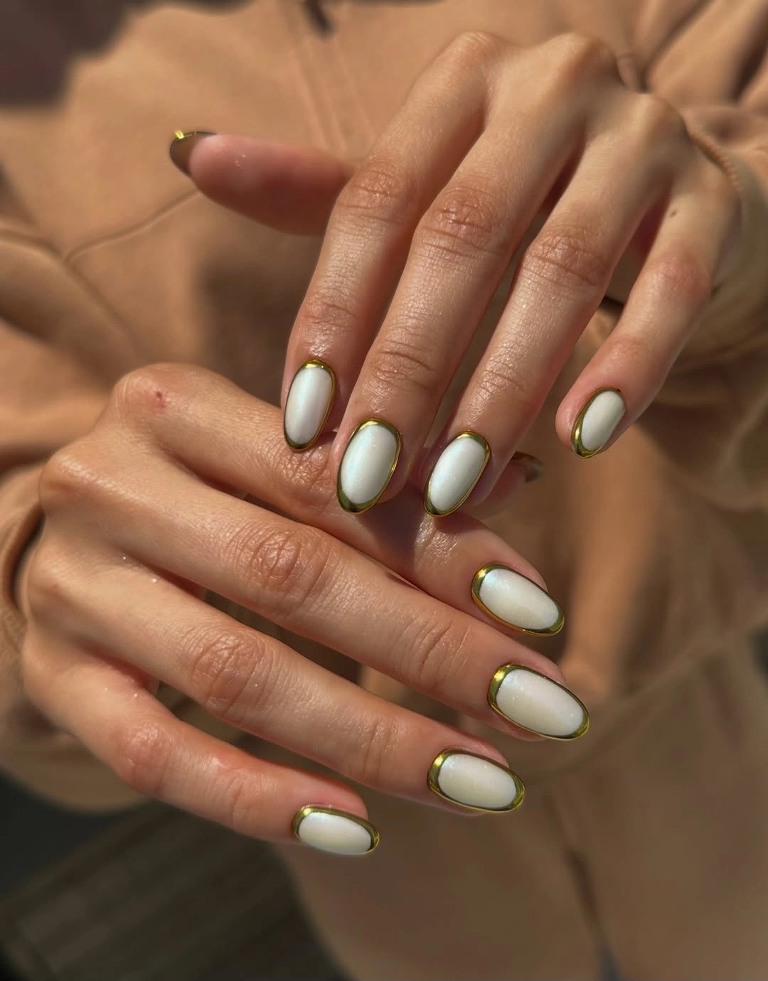 Milky white oval nails with thin olive green edging