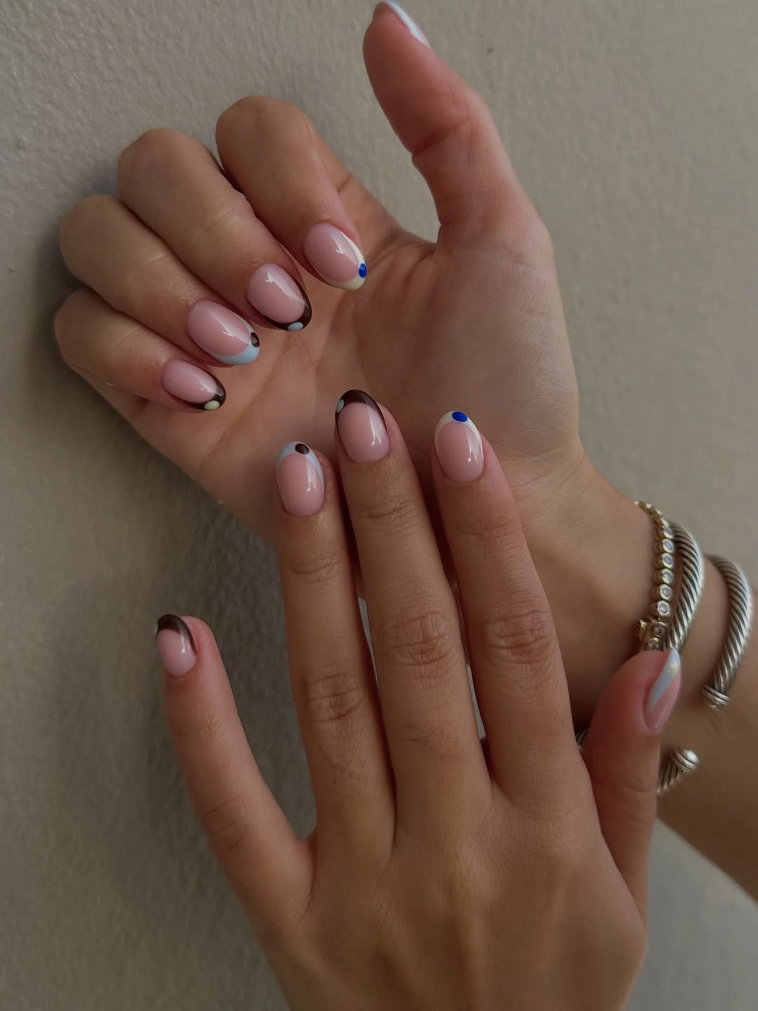 Short rounded lavender nails with tiny dark edge accents