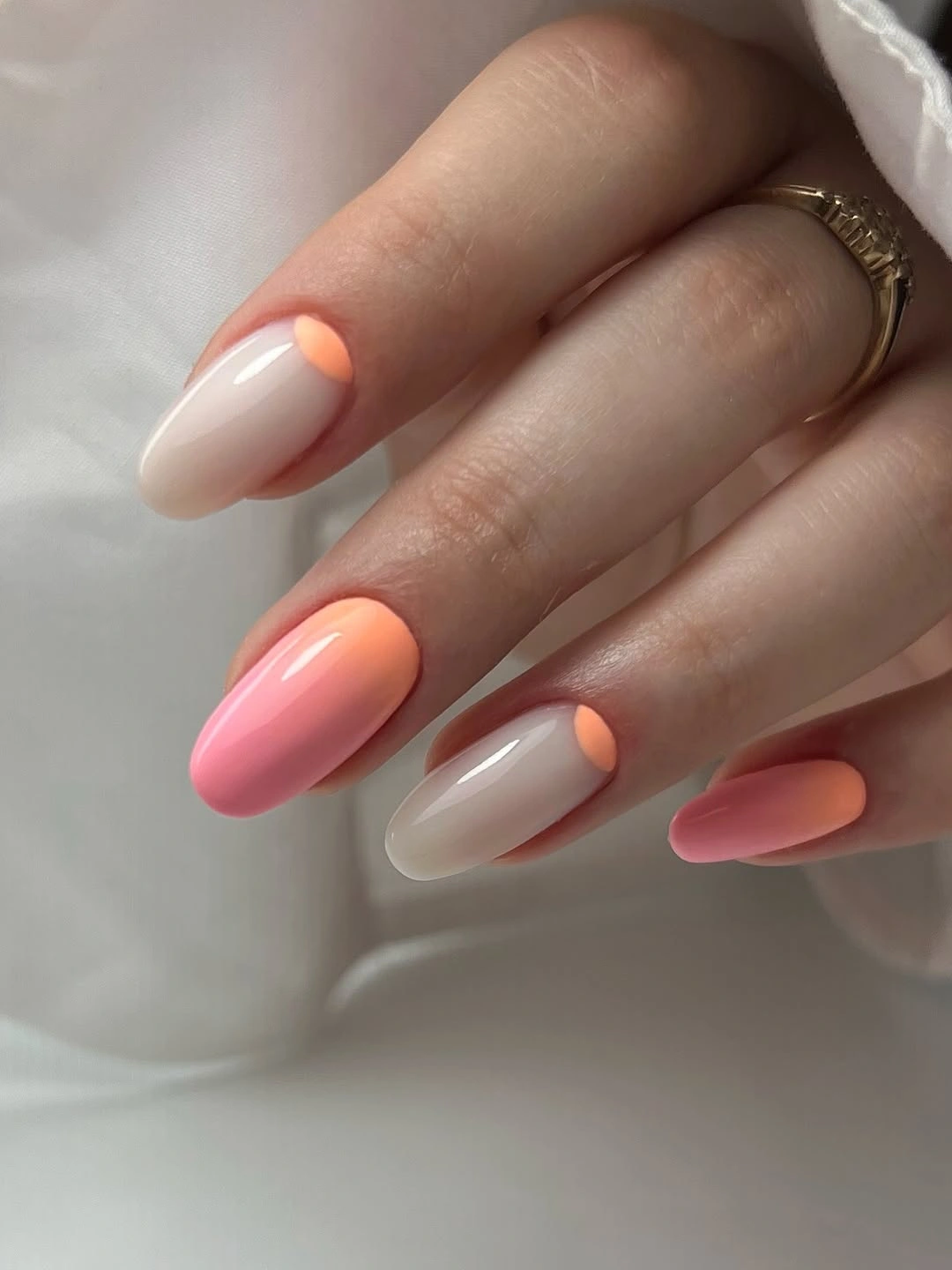 Glossy coral cream ombre almond nails with warm pink tips