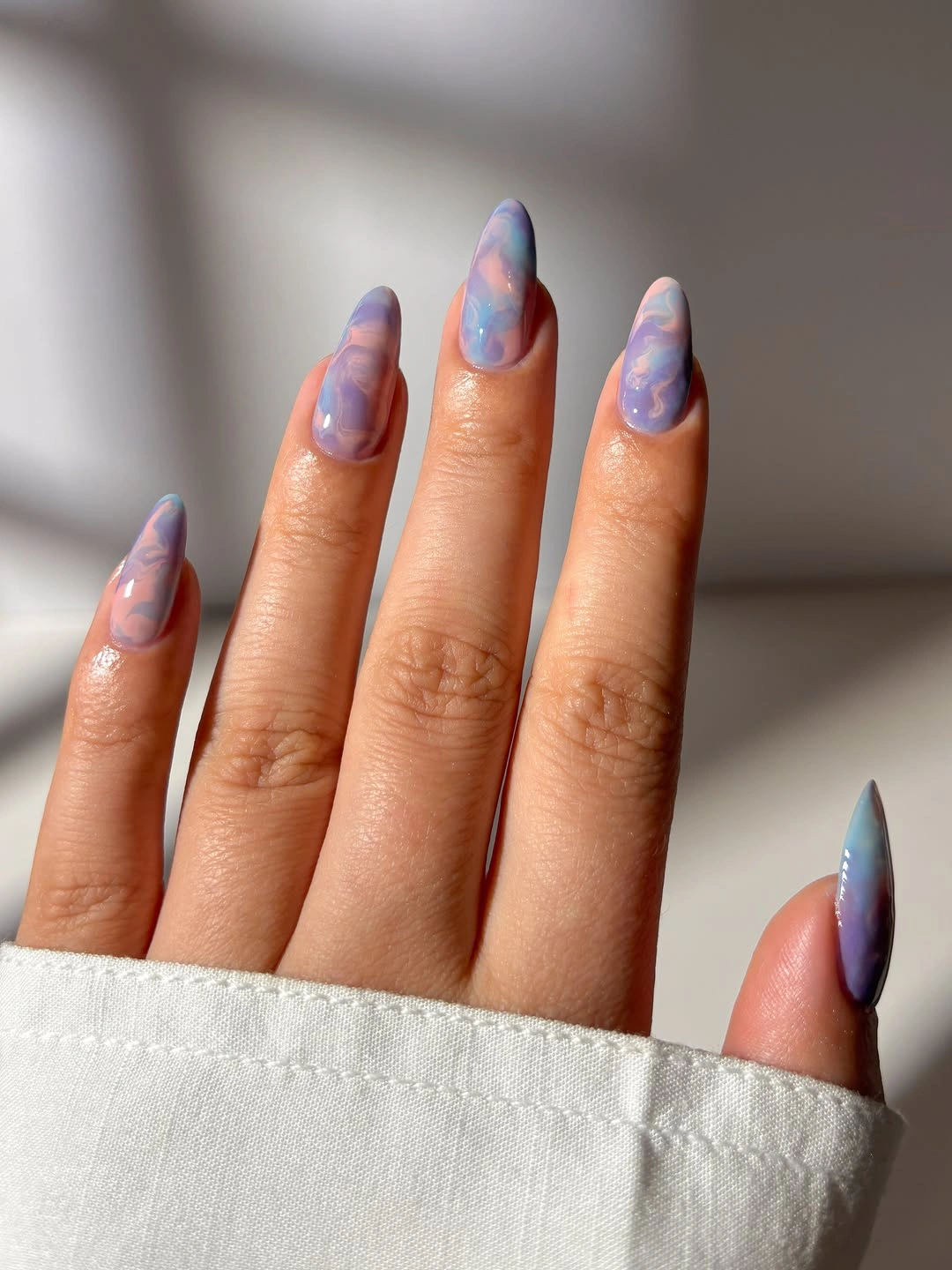 Long almond nails with a blue lavender and soft pink gradient