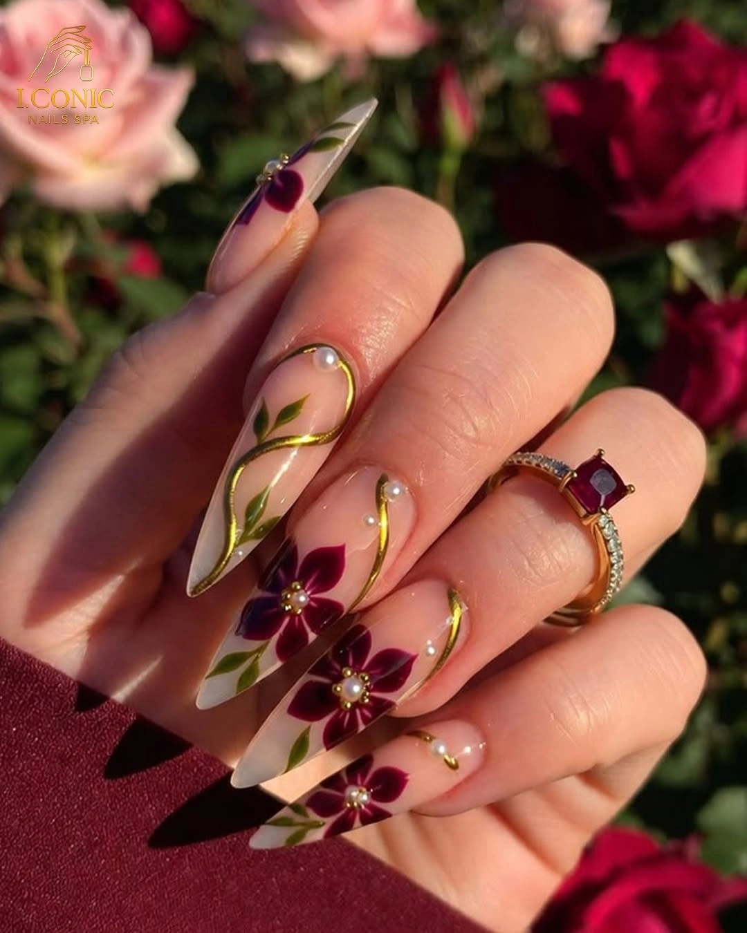 Burgundy almond wedding nails with floral linework and gold dots