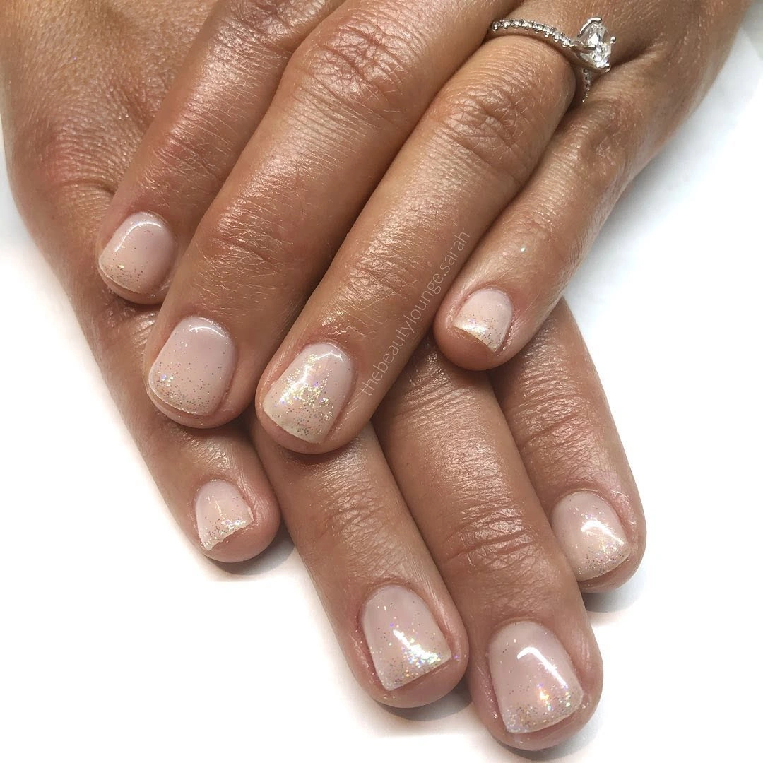 Short rounded nude pink wedding nails with fine white tips