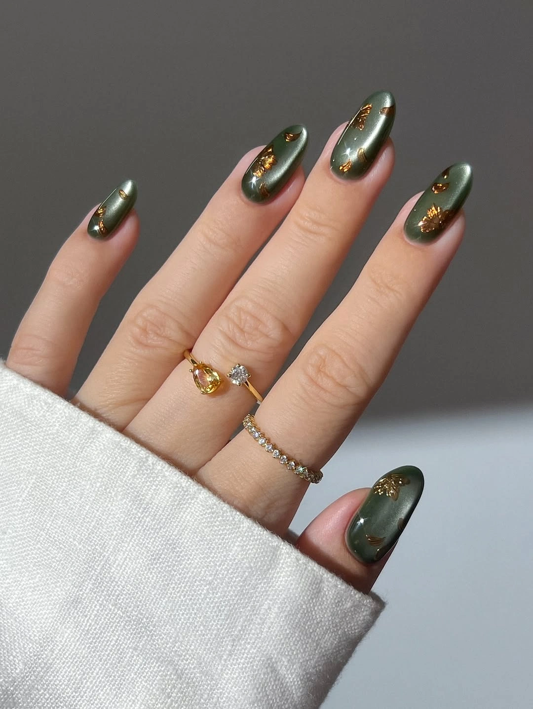 Deep olive almond wedding nails with gold curved accents