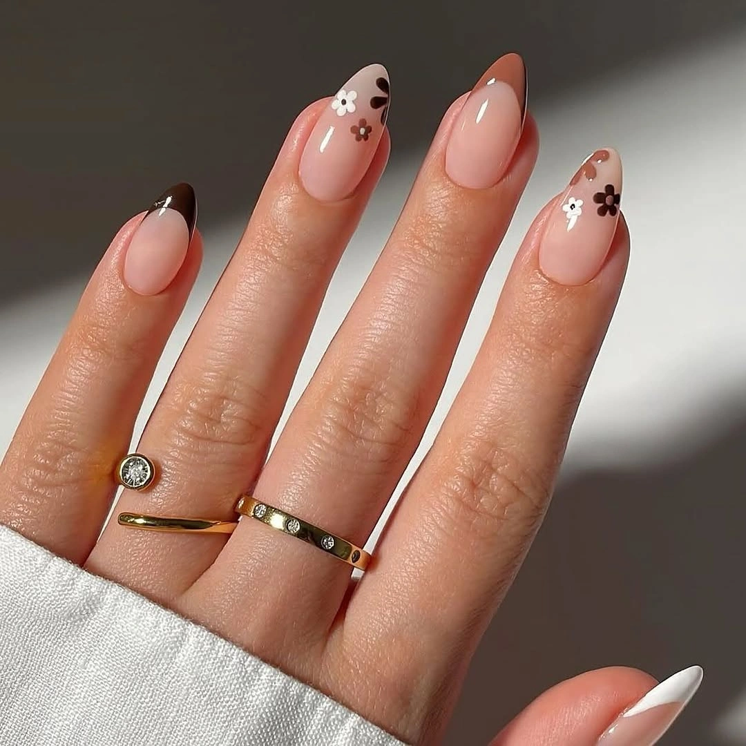 Peach almond wedding nails with tiny flowers and dark French edges