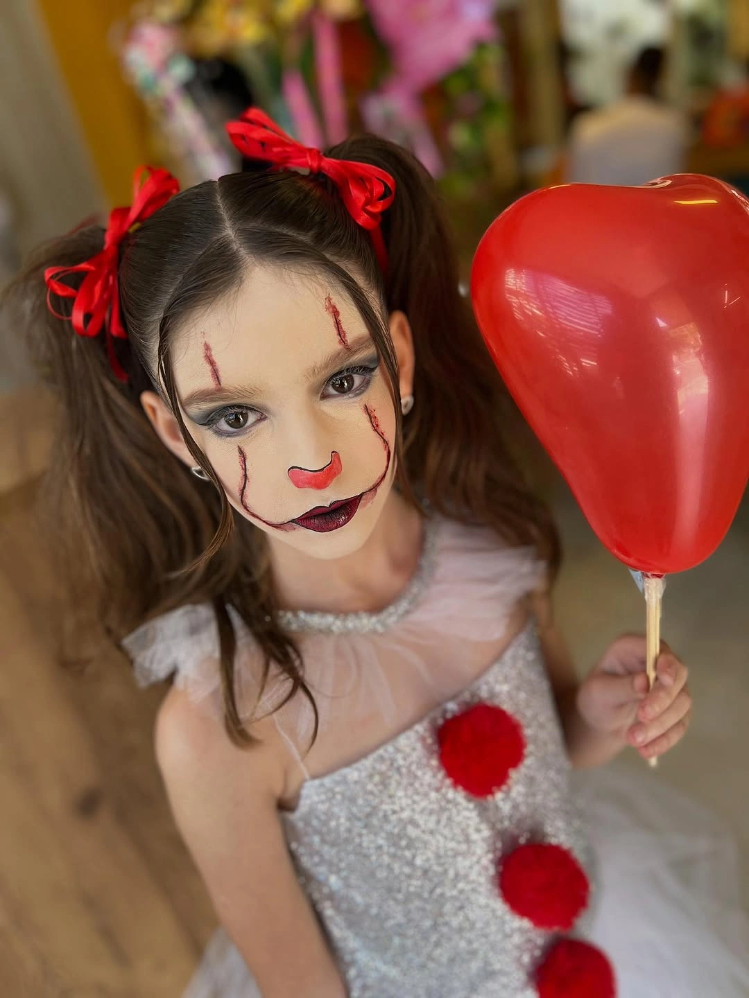 Kids white and silver clown costume with red pom-poms hair bows and red balloon