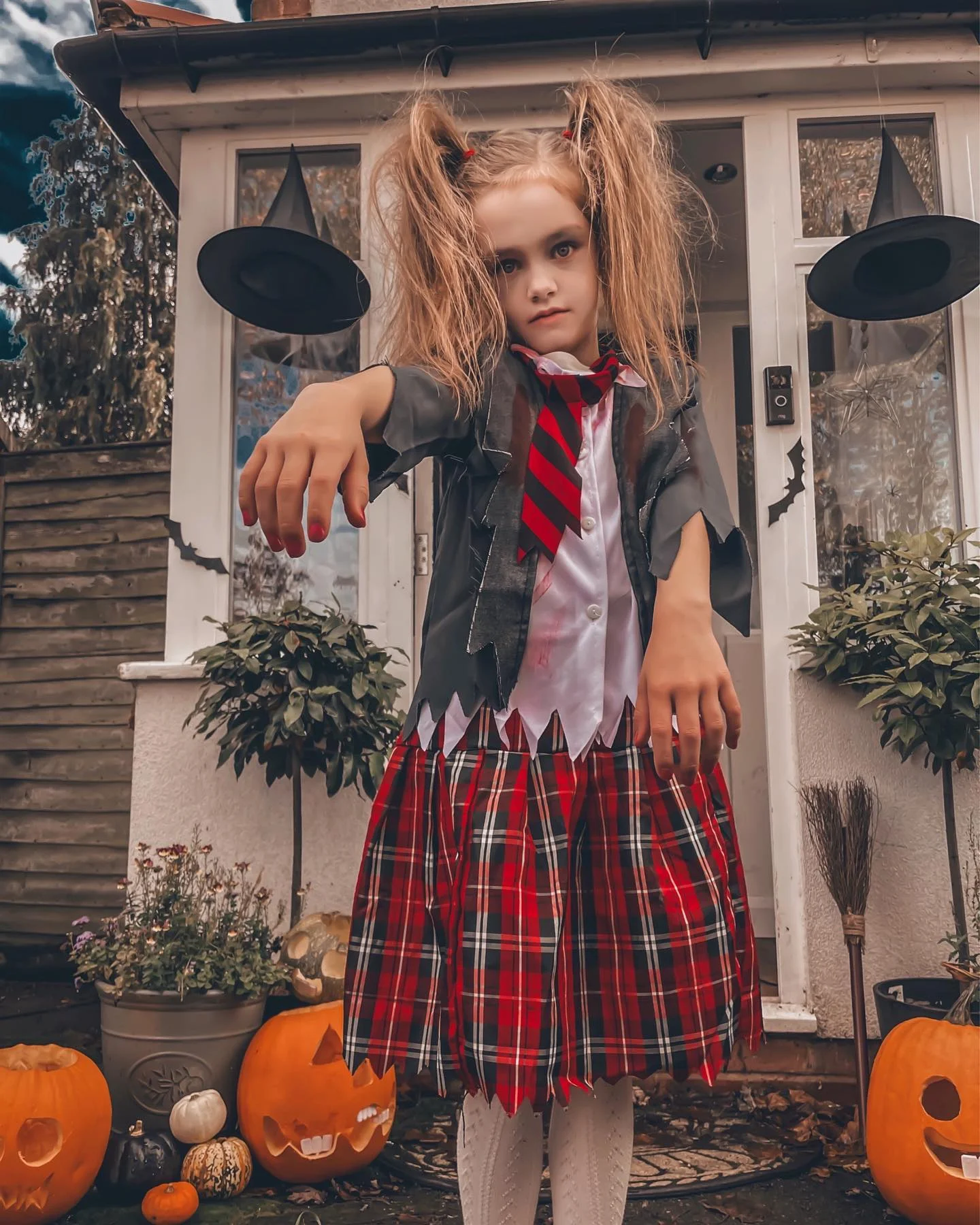 Kids zombie school costume with red plaid skirt white shirt striped tie and torn gray layer