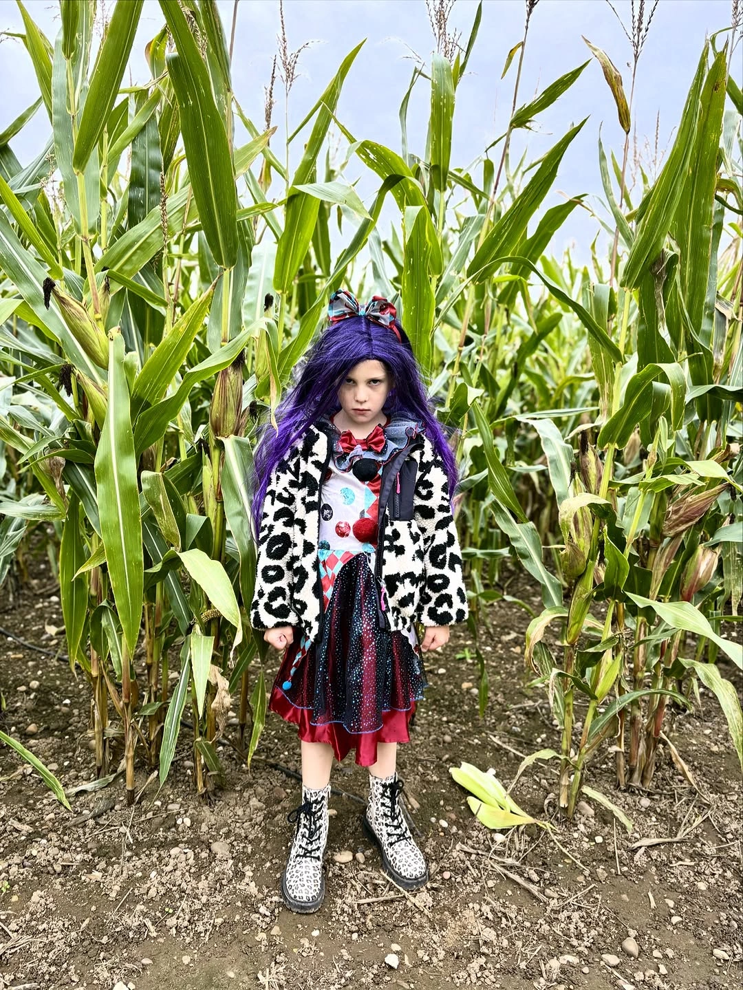 Kids purple wig costume with black-and-white spotted coat red-and-black layers and sneakers