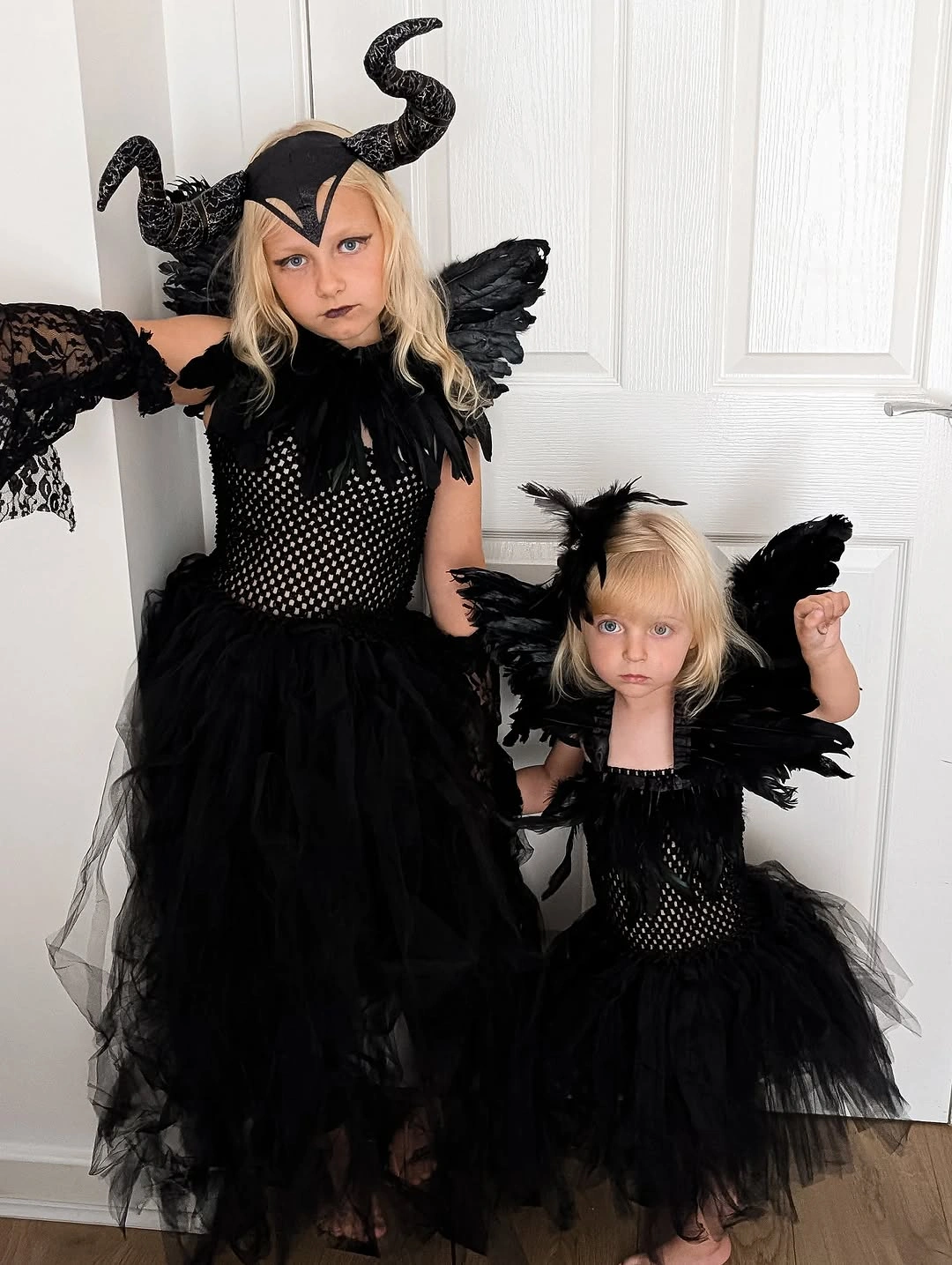 Kids black winged Halloween duo with horned headpiece layered dresses and dark accessories