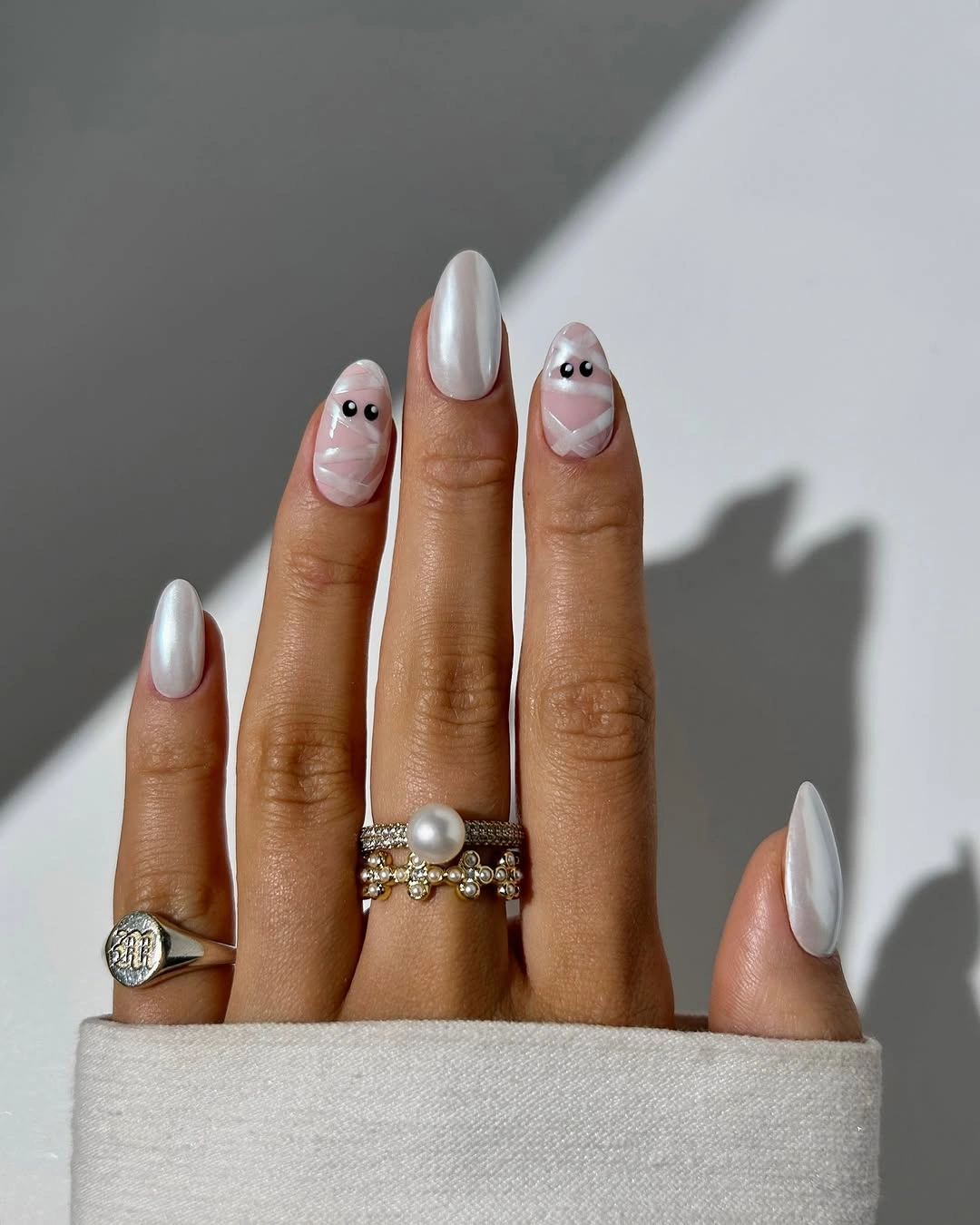 Long almond nails with white ghosts orange pumpkins and black accents
