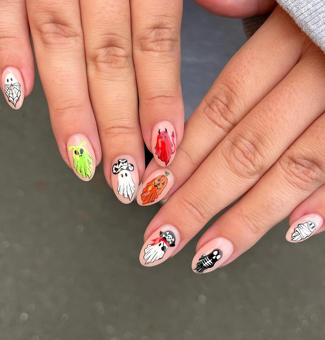 Short nude nails with colorful tiny ghosts and Halloween icons