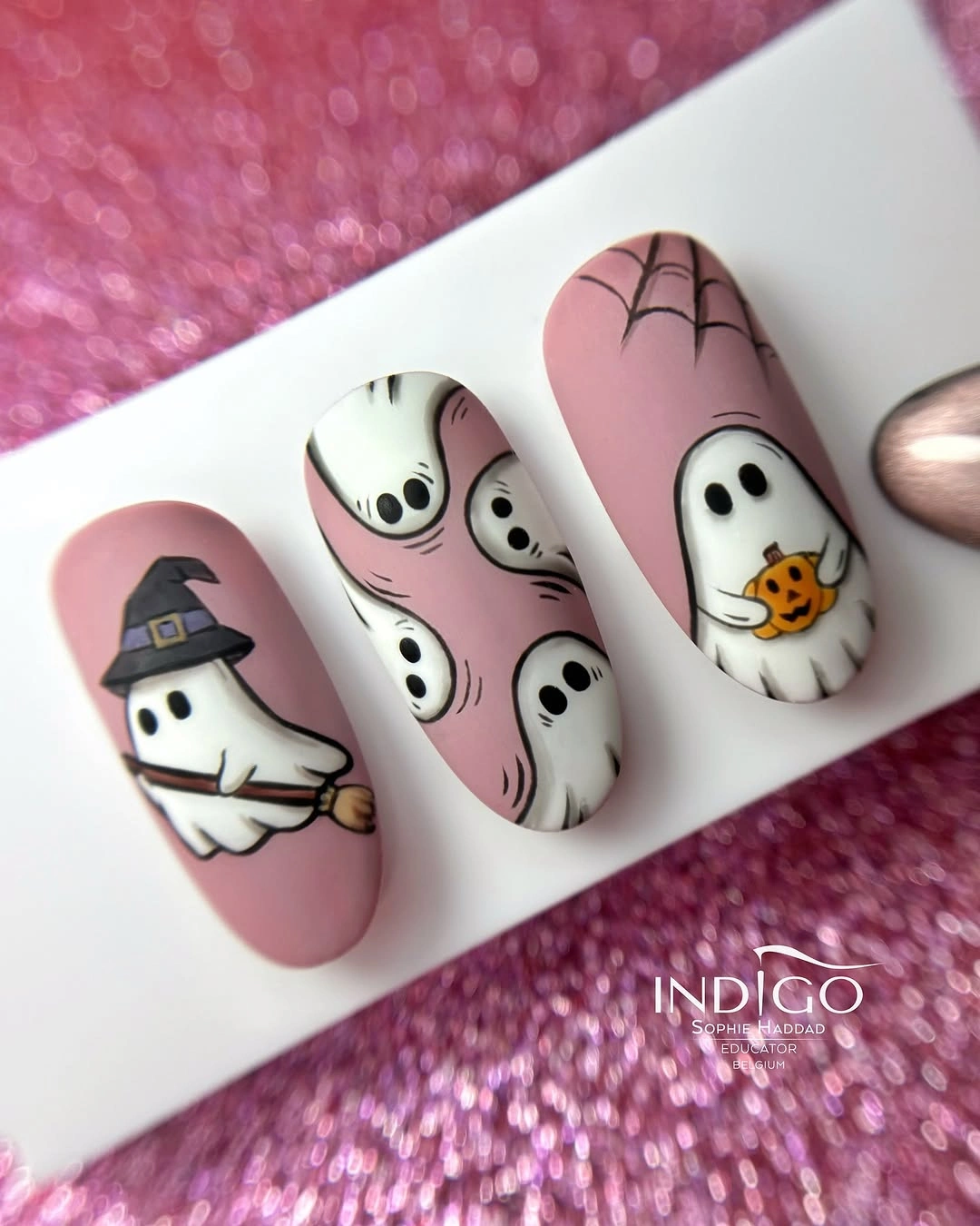Soft pink ghost nails with witch hat and Halloween accents