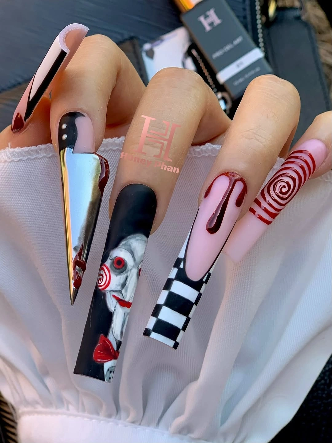 Very long square nails with pink black orange stripes and graphics