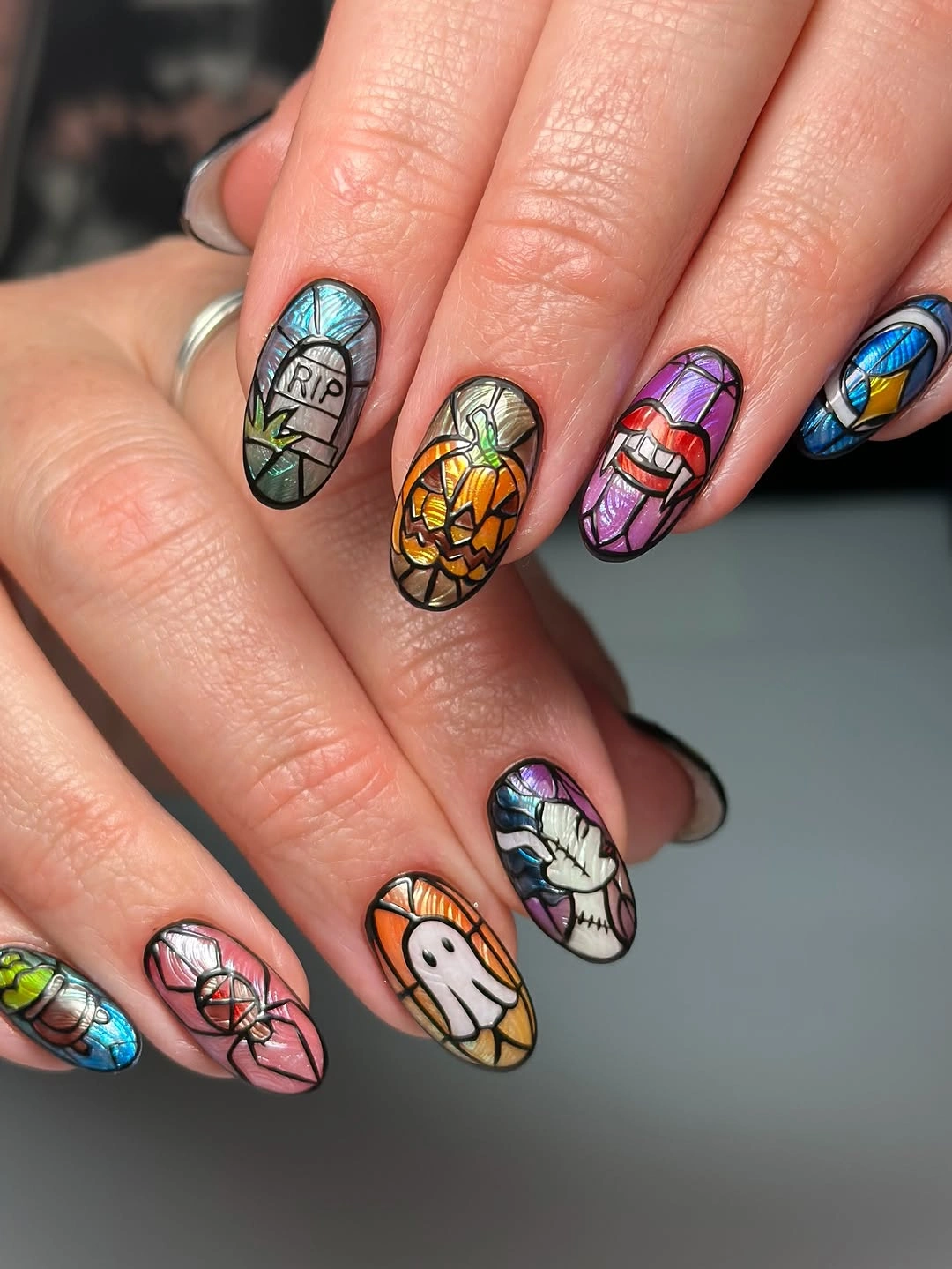 Short square nails with colorful miniature pumpkins and figures