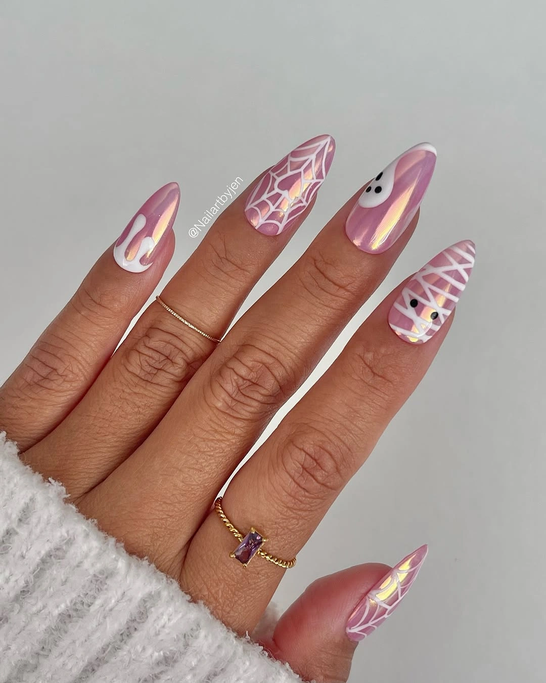 Pink stiletto nails with orange tips ghosts and metallic accents