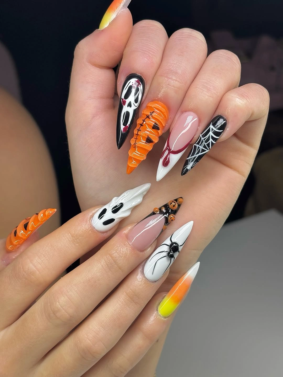 Black white and orange almond nails with playful ghosts
