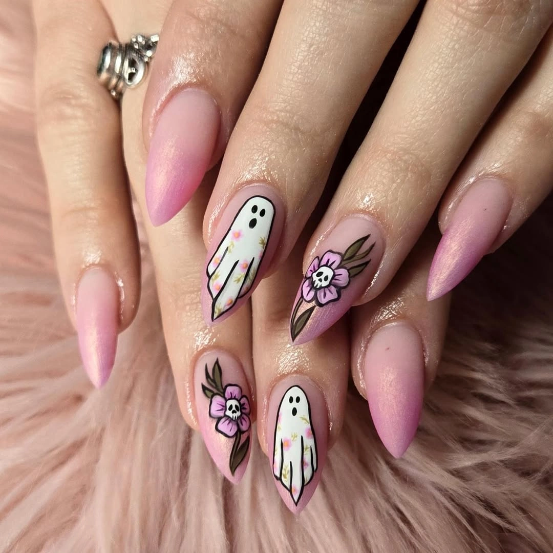 Pastel pink nails with pale ghosts spiderwebs and glitter