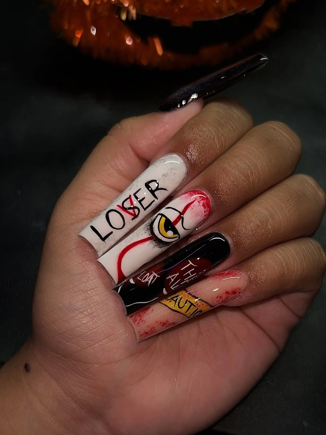 Long pop art nails with red black nude panels and lettering