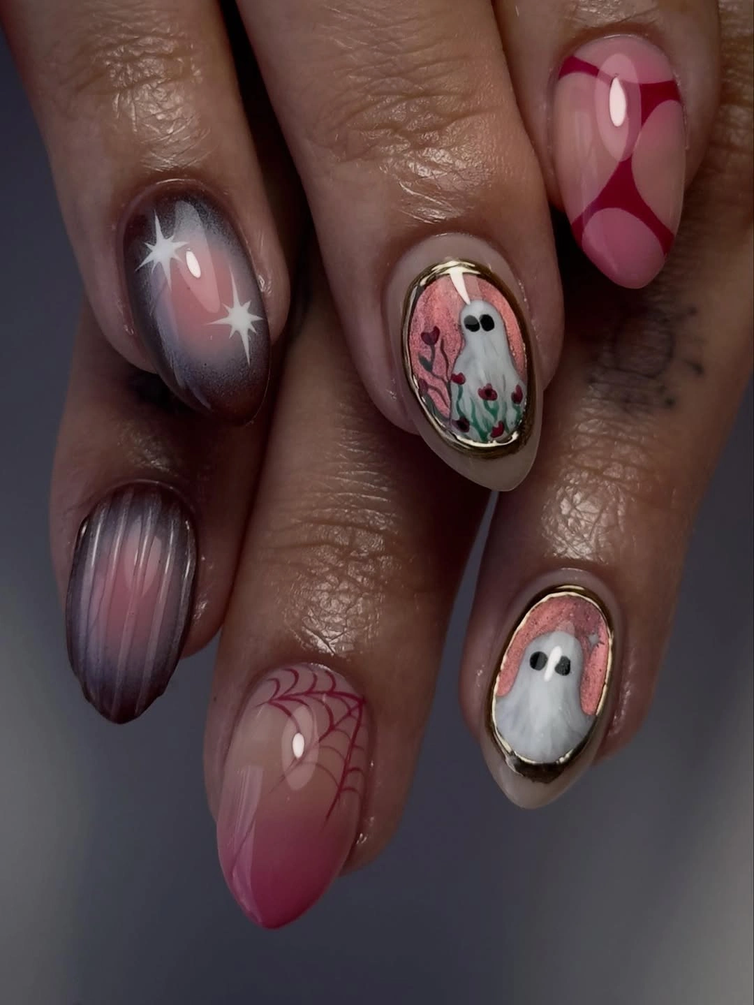 Translucent mauve oval nails with soft Halloween accents