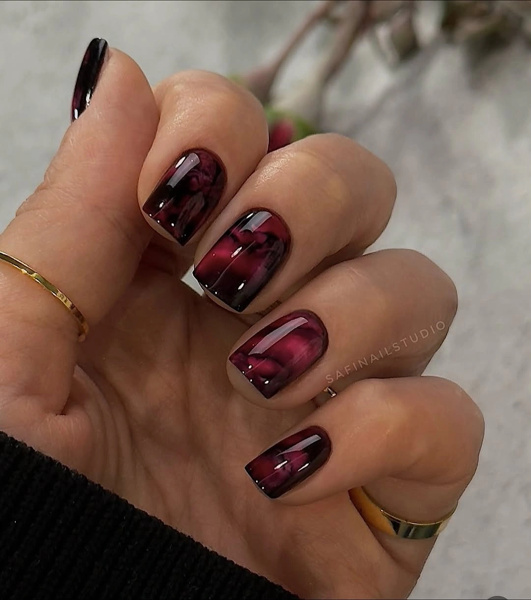 Short burgundy square nails with dark plaid pattern detail