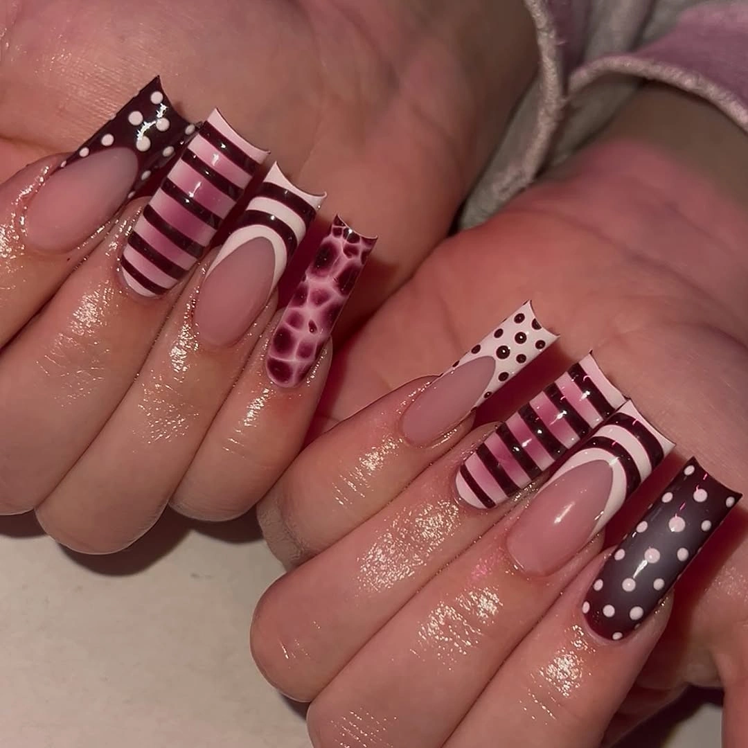 Long nude nails with maroon stripes dots and leopard accent