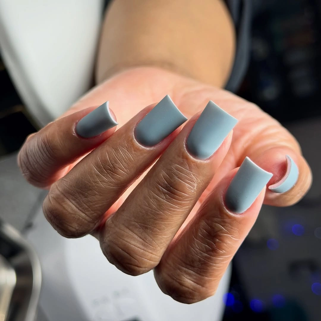 Long pale blue square nails with a smooth matte finish