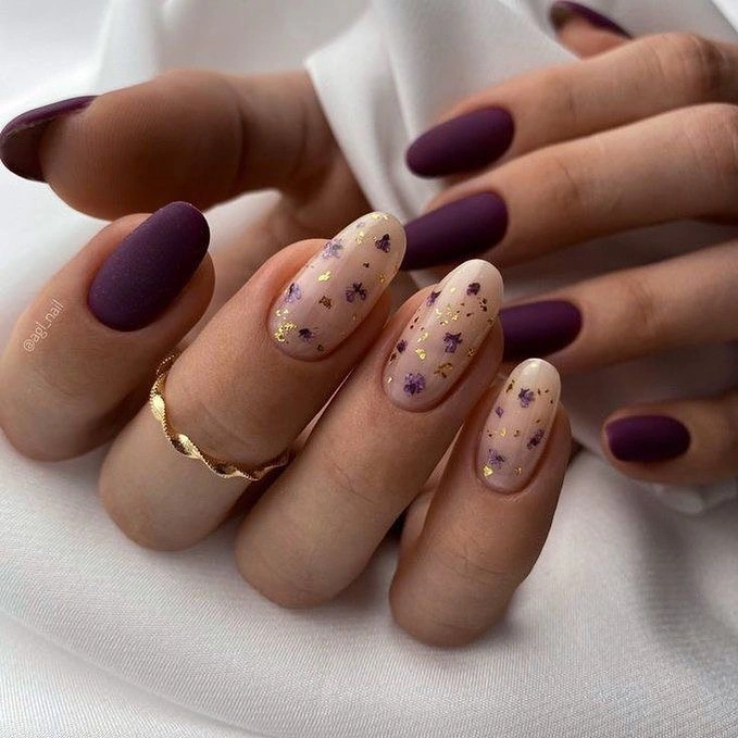 Deep plum matte almond nails with sheer floral accents