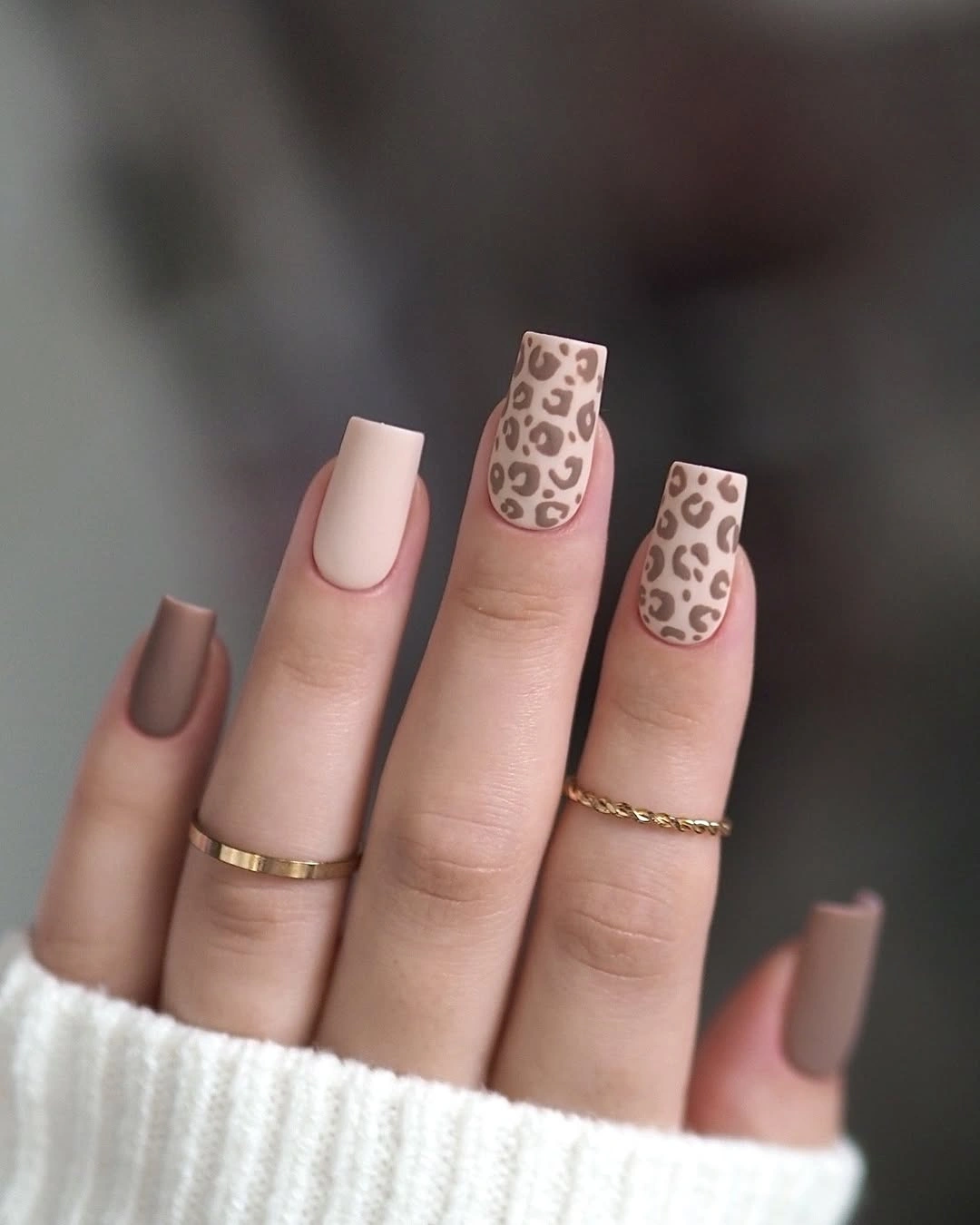 Neutral square nails with muted brown leopard print accents