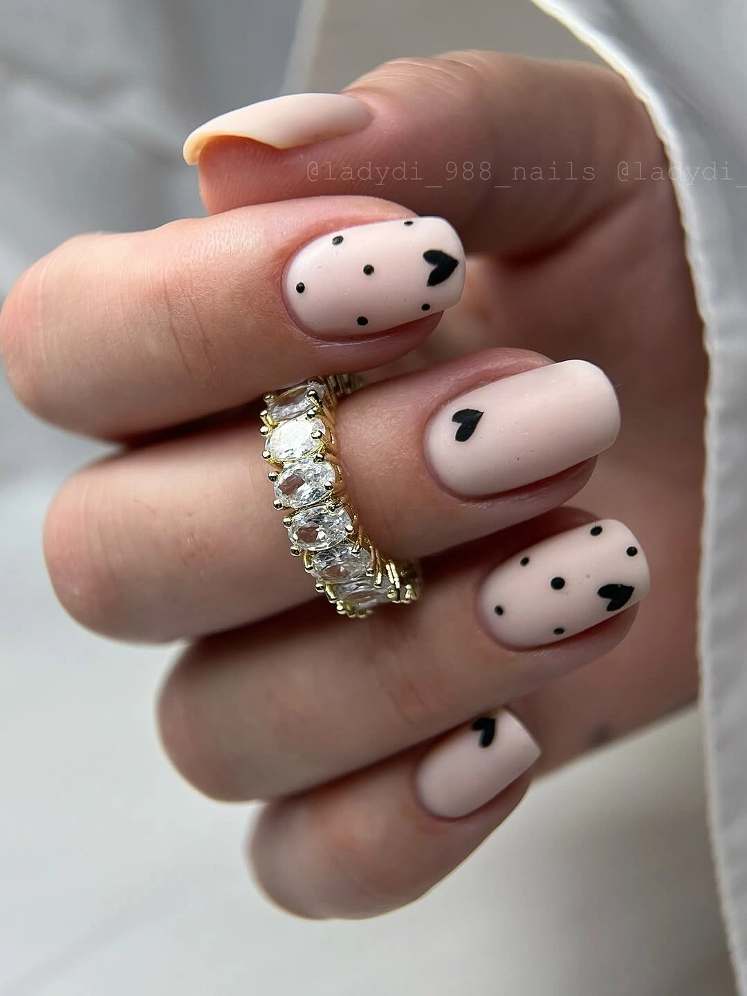Pale pink rounded nails with black and white cow spots