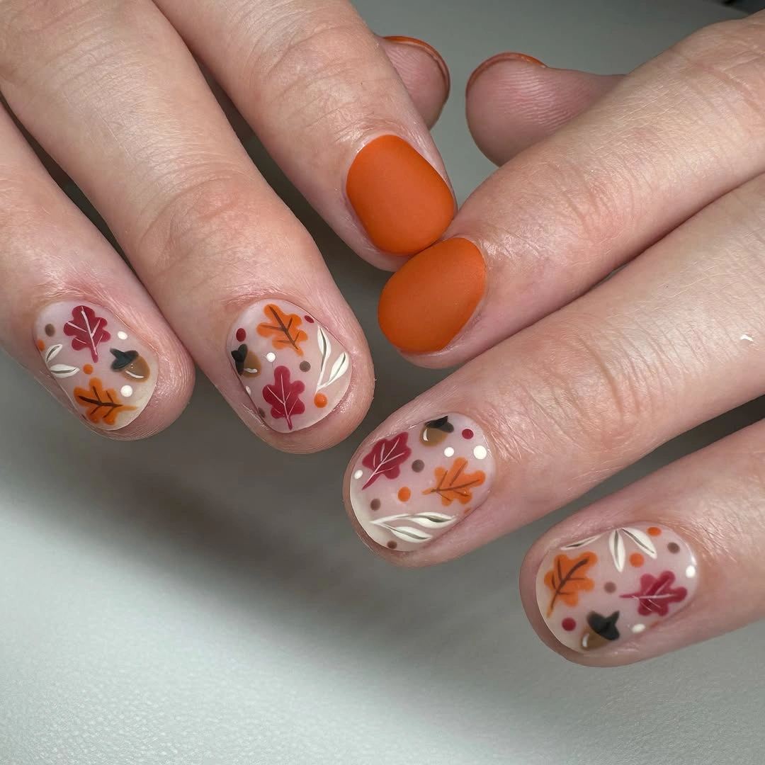 Short orange nails with sheer floral autumn accent nails