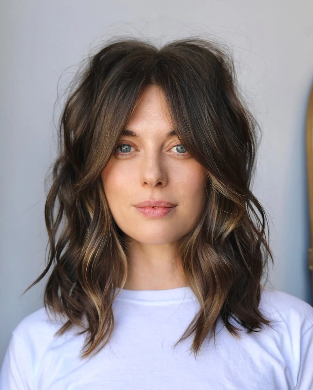 Shoulder length tousled middle part waves with open front pieces
