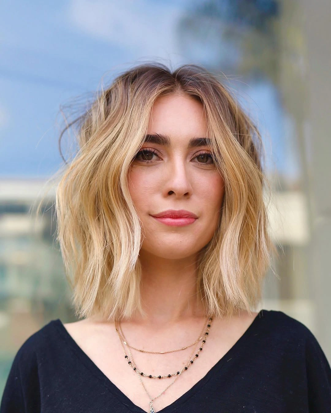 Soft blonde middle part bob with loose shoulder waves