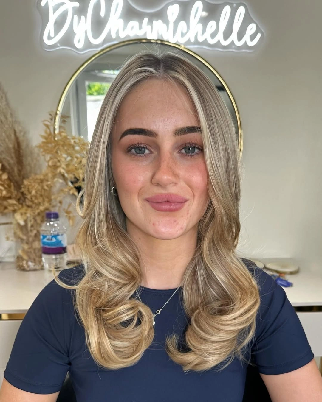 Polished blonde middle part waves with swept curtain ends